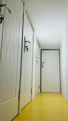 an empty hallway with white doors and a wooden floor at Modern Homestay Oval Tower, Business Bay in Dubai