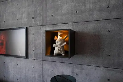 a statue of a bunny in a box on a wall at Designer Suite with Skyline views in Dubai