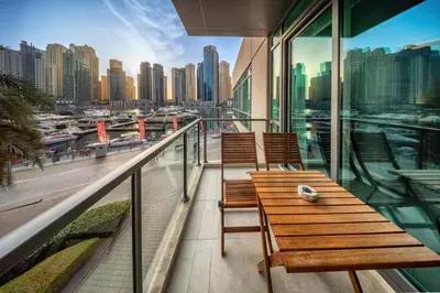 a balcony with two benches and a view of a city at Al Majara 1 BDR plus Guest Bedroom, Dubai Marina in Dubai