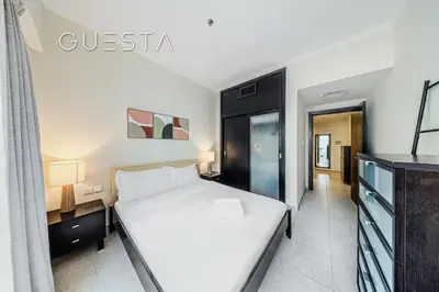 a bedroom with a bed and a tv in a room at Al Majara 1 BDR plus Guest Bedroom, Dubai Marina in Dubai