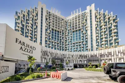 a large building with a parking lot in front of it at TRPS - Farhad Azizi, Al Jaddaf - Premium 1BR, Furnished with Pool View in Dubai