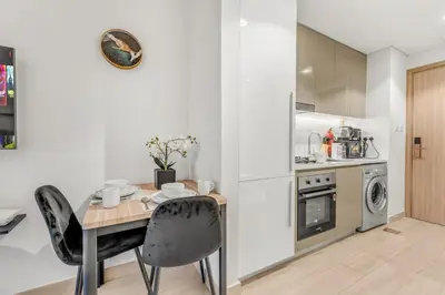 a kitchen and dining room with a table and chairs at Luxury Apartments in Meydan in Dubai