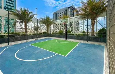 a basketball court with a basketball hoop at Bella Casa - Luxury 1BR Apartment - Brand New Furniture in Dubai