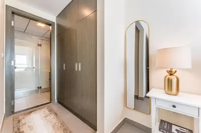 a bathroom with a shower and a mirror at Bella Casa - Luxury 1BR Apartment - Brand New Furniture in Dubai
