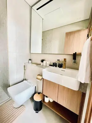 a white bathroom with a sink and a mirror at Fully Equipped Studio with Kitchen and Free Wi-Fi in Dubai
