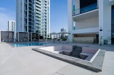 a view of a building with a swimming pool at Fully Equipped Studio with Kitchen and Free Wi-Fi in Dubai