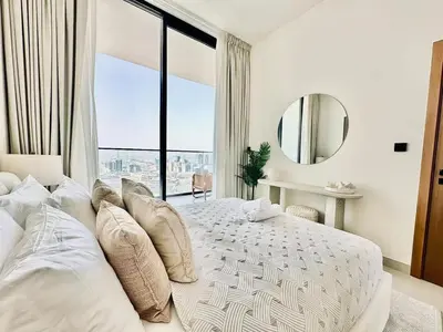 a bedroom with a large bed with a large window at Cloud Level 1BR Calm with Parking Pool & Gym in Dubai