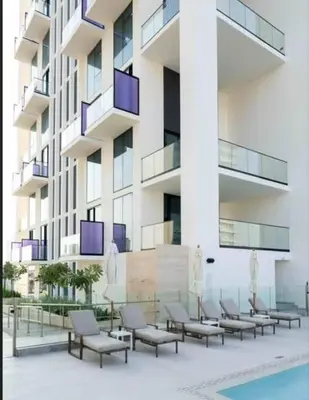 a row of chairs in front of a building at Cloud Level 1BR Calm with Parking Pool & Gym in Dubai