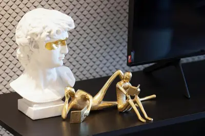 a statue of a woman with a sandal on a table at Boulevard Point 3BR plus Maid Direct Access to DXB Mall in Dubai