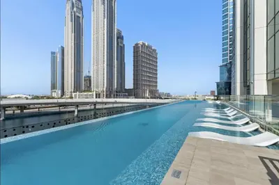 a swimming pool in the middle of a city with tall buildings at Live the Opulenco Experience! 2BR Urban Oasis by Missoni, Business Bay in Dubai