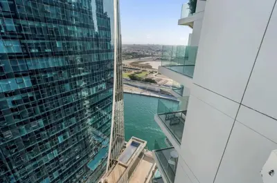 a view of a tall building with a body of water at Live the Opulenco Experience! 2BR Urban Oasis by Missoni, Business Bay in Dubai