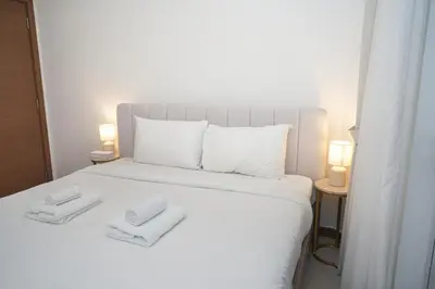 a white bed with two white towels on it at Live the Opulenco Experience! 2BR Urban Oasis by Missoni, Business Bay in Dubai