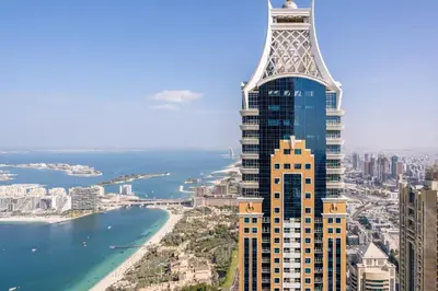 a tall skyscraper with a view of the ocean at FIRST CLASS 1BR High Floor Luxury & Palm View in Dubai