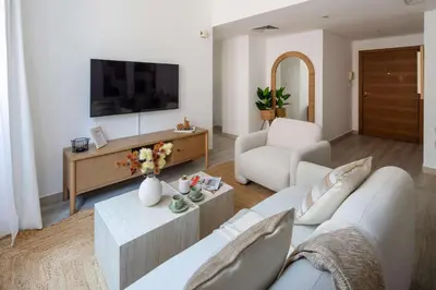 a living room with a couch and a tv at Frank Porter - Claren Tower 2, Downtown in Dubai