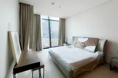 a bedroom with a bed and a large window at Private room in BURJ KHALIFA facing 3BR luxury apartment in Downtown Near Dubai Mall Metro in Dubai