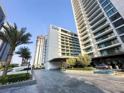 a large white building with palm trees in front of it at FIRST CLASS 1BR Luxe Living with a View in Dubai