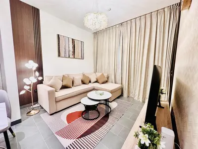 a living room with a couch and a table at Modern 02 Bedroom in Sobha Crest B in Dubai