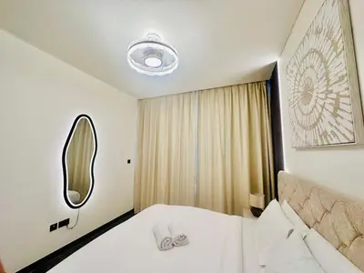 a hotel room with a bed and a mirror at Modern 02 Bedroom in Sobha Crest B in Dubai