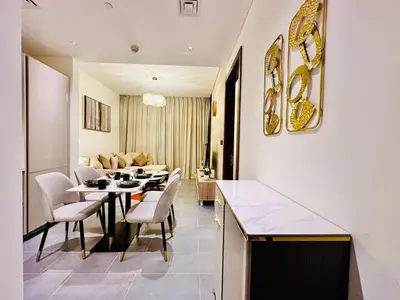 a living room with a table and chairs and a couch at Modern 02 Bedroom in Sobha Crest B in Dubai