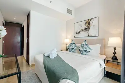 a bedroom with a large white bed in a room at 2BR Downtown Gem with Burj Khalifa and Fountain Views in Dubai