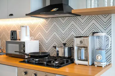 a kitchen counter with a stove and appliances on it at 1BR Little Haven in Collective T1, Dubai Hills in Dubai