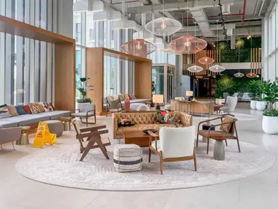 a lobby with a lot of furniture and large windows at 1BR Little Haven in Collective T1, Dubai Hills in Dubai