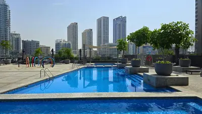 a swimming pool with a city skyline in the background at Sparkle Tower by Swarovski, Full Marina View, 2min JBR & Metro, Sleeps 4 in Dubai