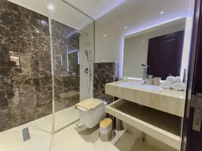 a bathroom with a shower and a toilet and a sink at Central & Luxurious 2BR- Burj Khalifa & Dubai Mall in Dubai