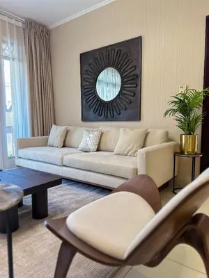 a living room with a couch and a mirror at Central & Luxurious 2BR- Burj Khalifa & Dubai Mall in Dubai