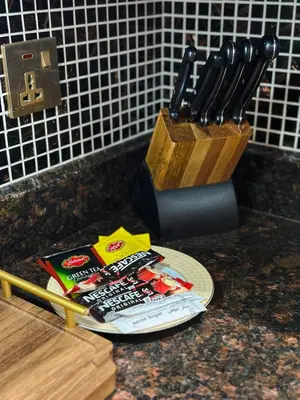 a counter top with a knife block and a magazine at Central & Luxurious 2BR- Burj Khalifa & Dubai Mall in Dubai