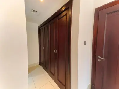 a corridor with a wooden door in a room at Central & Luxurious 2BR- Burj Khalifa & Dubai Mall in Dubai