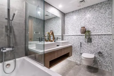 a bathroom with two sinks and a tub and a toilet at The Smart Concierge - Stella Maris in Dubai