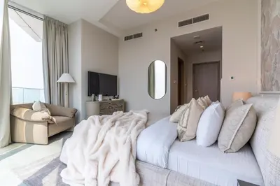 a living room with a large white couch with pillows at The Smart Concierge - Stella Maris in Dubai