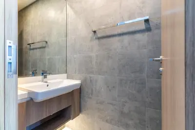 a bathroom with a sink and a shower at The Smart Concierge - Stella Maris in Dubai