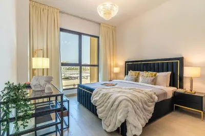 a bedroom with a bed and a large window at The Smart Concierge - Jadeel 1 MJL in Dubai