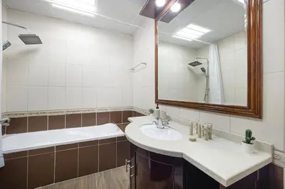 a bathroom with a sink and a mirror and a tub at Elegant 3BR Lux Stay in the Heart of Dubai Marina in Dubai
