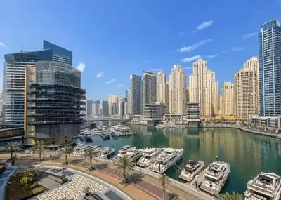 a group of boats in a harbor in a city at Elegant 3BR Lux Stay in the Heart of Dubai Marina in Dubai