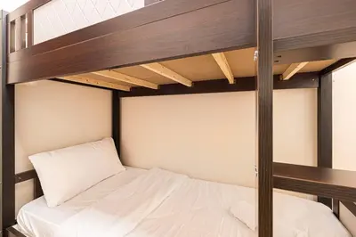 a bedroom with two bunk beds with white sheets at Elegant 3BR Lux Stay in the Heart of Dubai Marina in Dubai