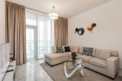 a living room with a couch and a table at Stylish 1BR Apartment at Meera Tower in Dubai