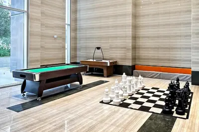 a billiard room with a table and a chessboard at Stylish 1BR Apartment at Meera Tower in Dubai