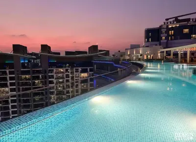 a large swimming pool on top of a building at Beachfront Bliss, Seven Palm Studio Apartment in Dubai