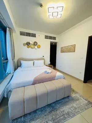a bedroom with a large bed with a large ottoman at Versatile 1BR with Burj Khalifa View in Dubai