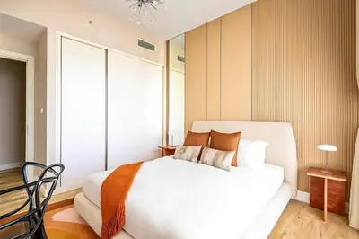 a bedroom with a white bed and a window at Serene Ocean Views, 2BR Emaar Beachfront in Dubai