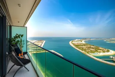 a room with a balcony with a view of the ocean at Serene Ocean Views, 2BR Emaar Beachfront in Dubai