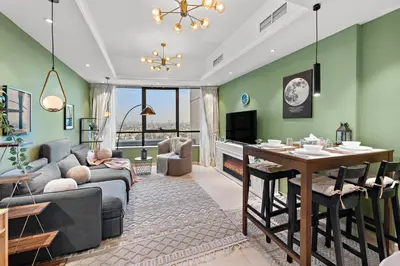 a living room with a couch and a table at Modern Apt just Steps to Metro & Lake with Pool andParking in Dubai
