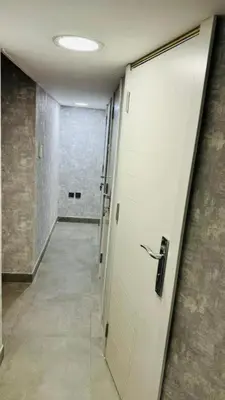 a hallway with a door leading to a room with a hallway at Oval Tower Retreat, Business Bay in Dubai