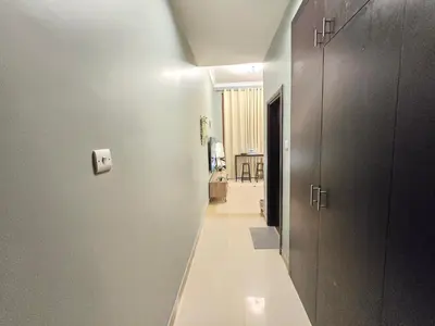 a hallway leading to a room with a hallway at Modern Studio Near Dubai World Trade Centre in Dubai
