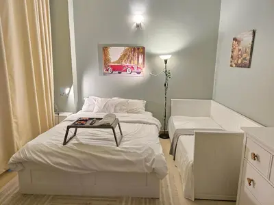 a bedroom with two beds and a table on the bed at Modern Studio Near Dubai World Trade Centre in Dubai
