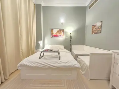 a small room with a bed and a bath tub at Modern Studio Near Dubai World Trade Centre in Dubai