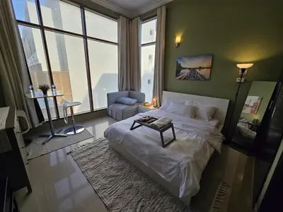 a bedroom with a large bed with a table on it at Charming Studio Near World Trade Center & Subway in Dubai